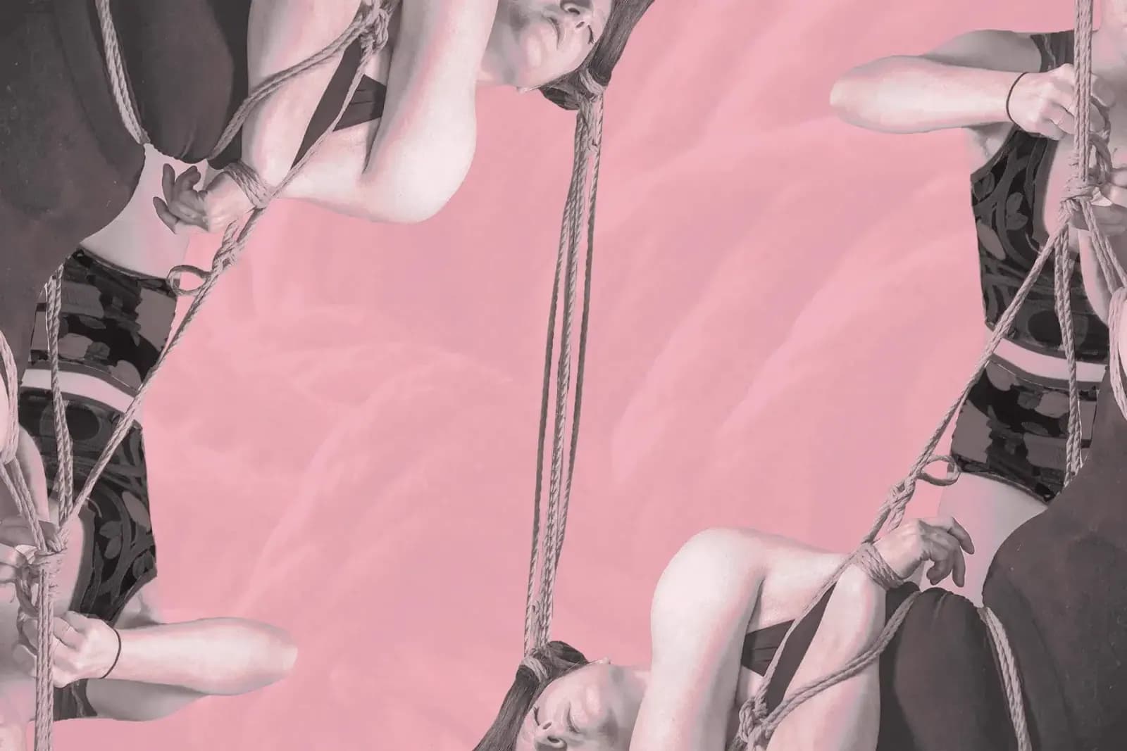 A rigger and bottom are tying a shibari suspension with hair rope on a pink background.