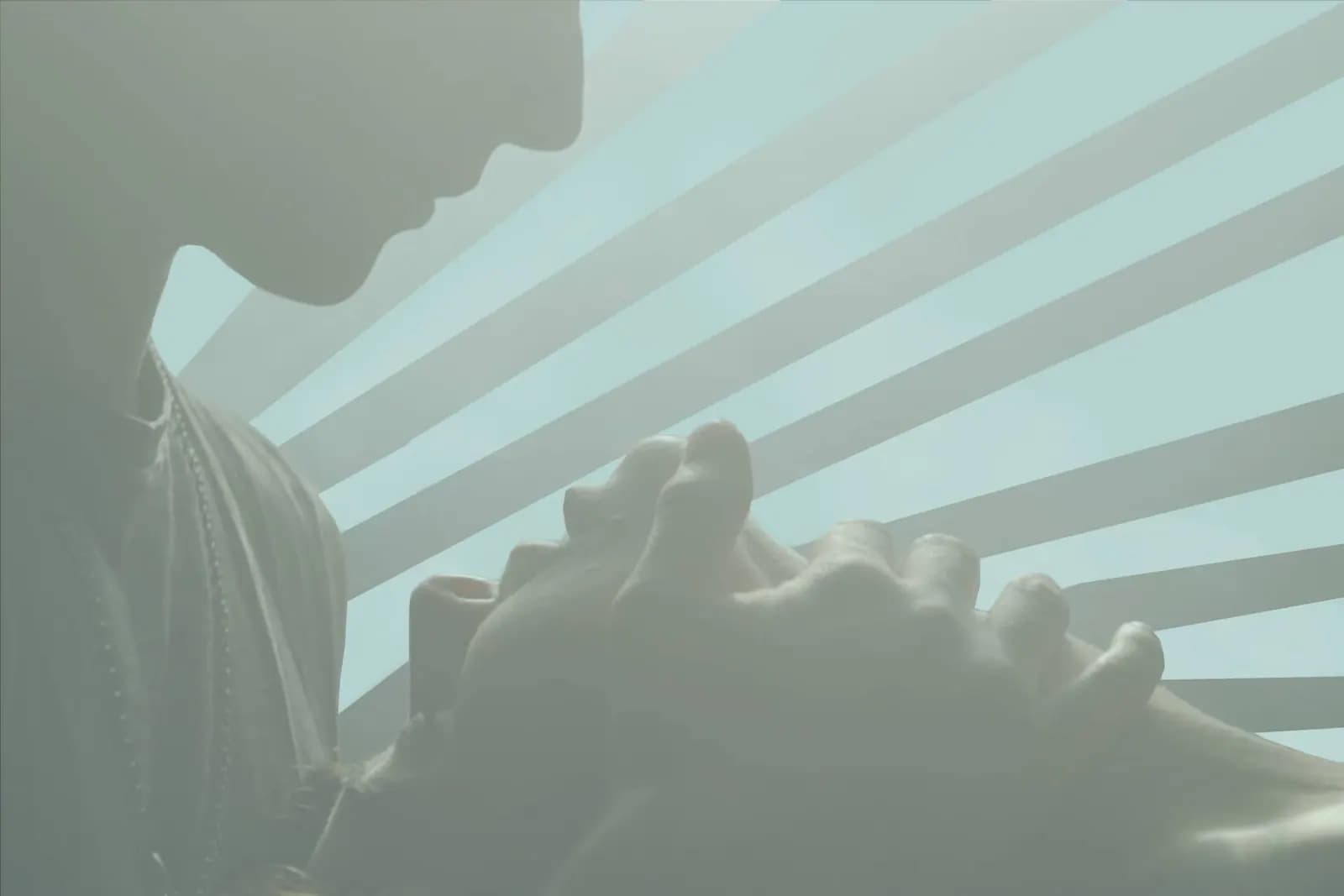 man caressing woman's face in a sensual setting.
