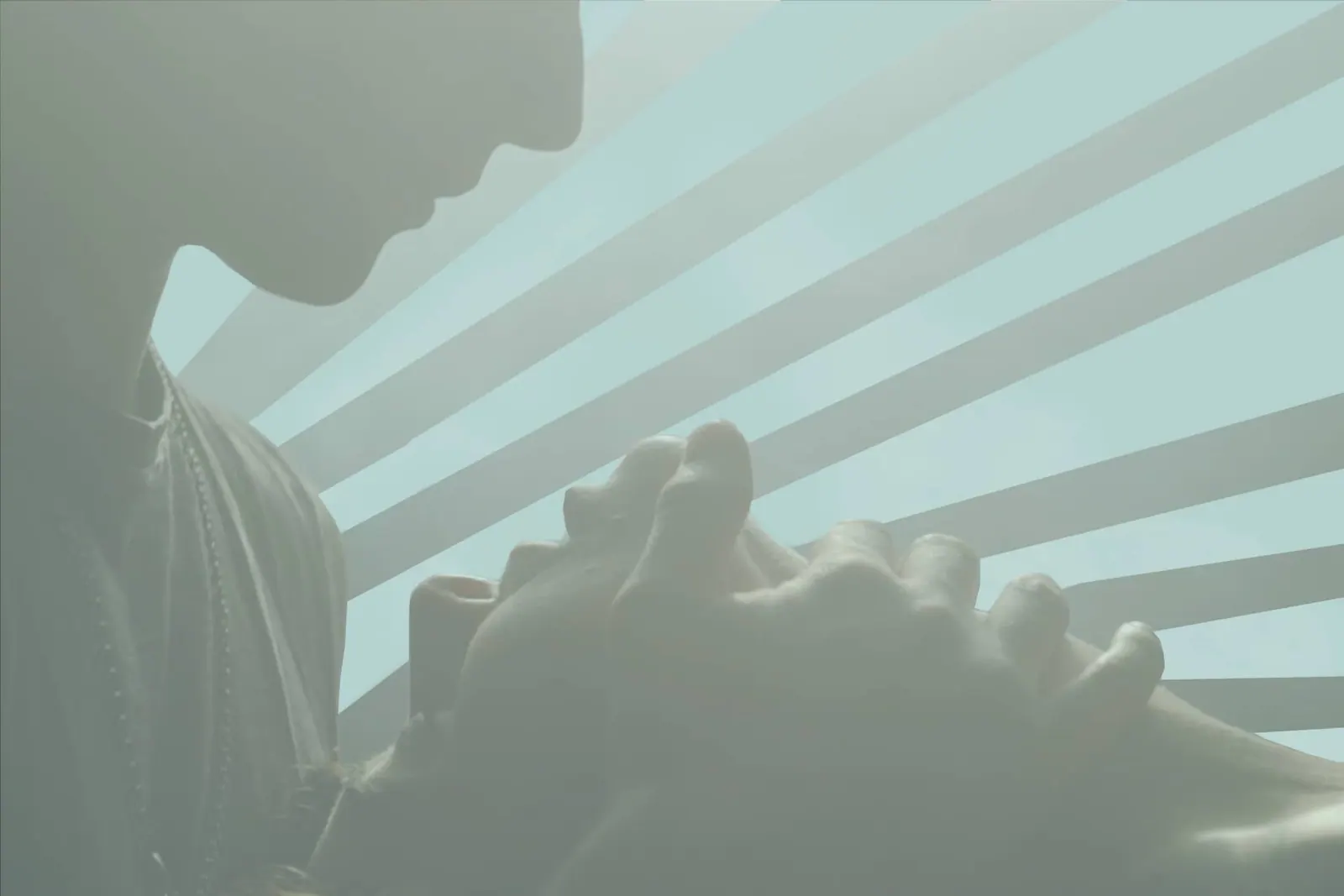 man caressing woman's face in a sensual setting.