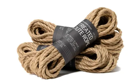 Multiple coils of natural jute rope bundled together with branded bands.