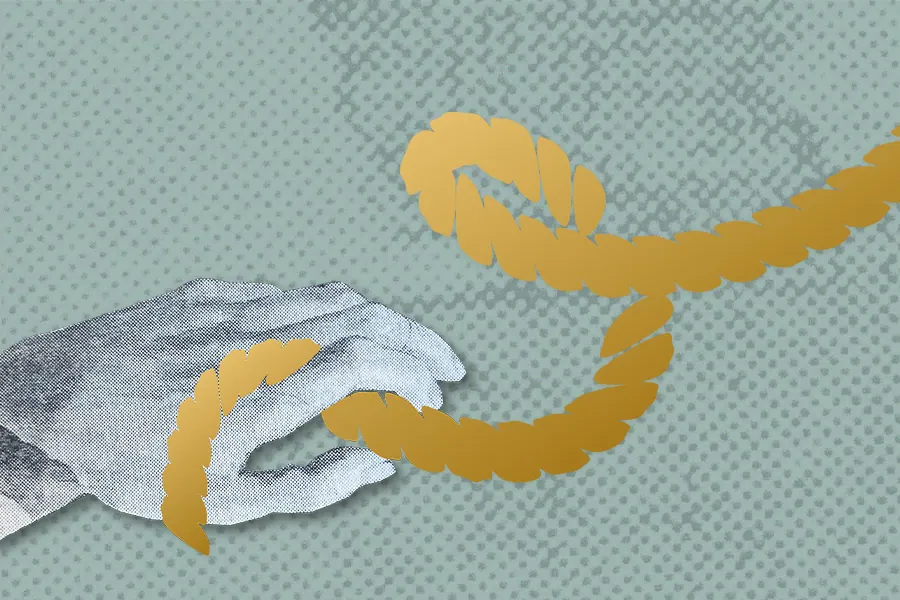 A golden shibari rope wrapped around a hand in front of a green background.