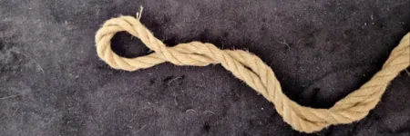 Close-up of jute rope showing burnt-out bight and fiber damage.