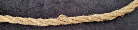 Close-up of jute rope showing separated fibers and high stranding.