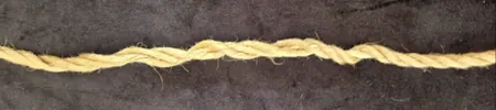 Close-up of jute rope showing uneven wear and damage patterns.